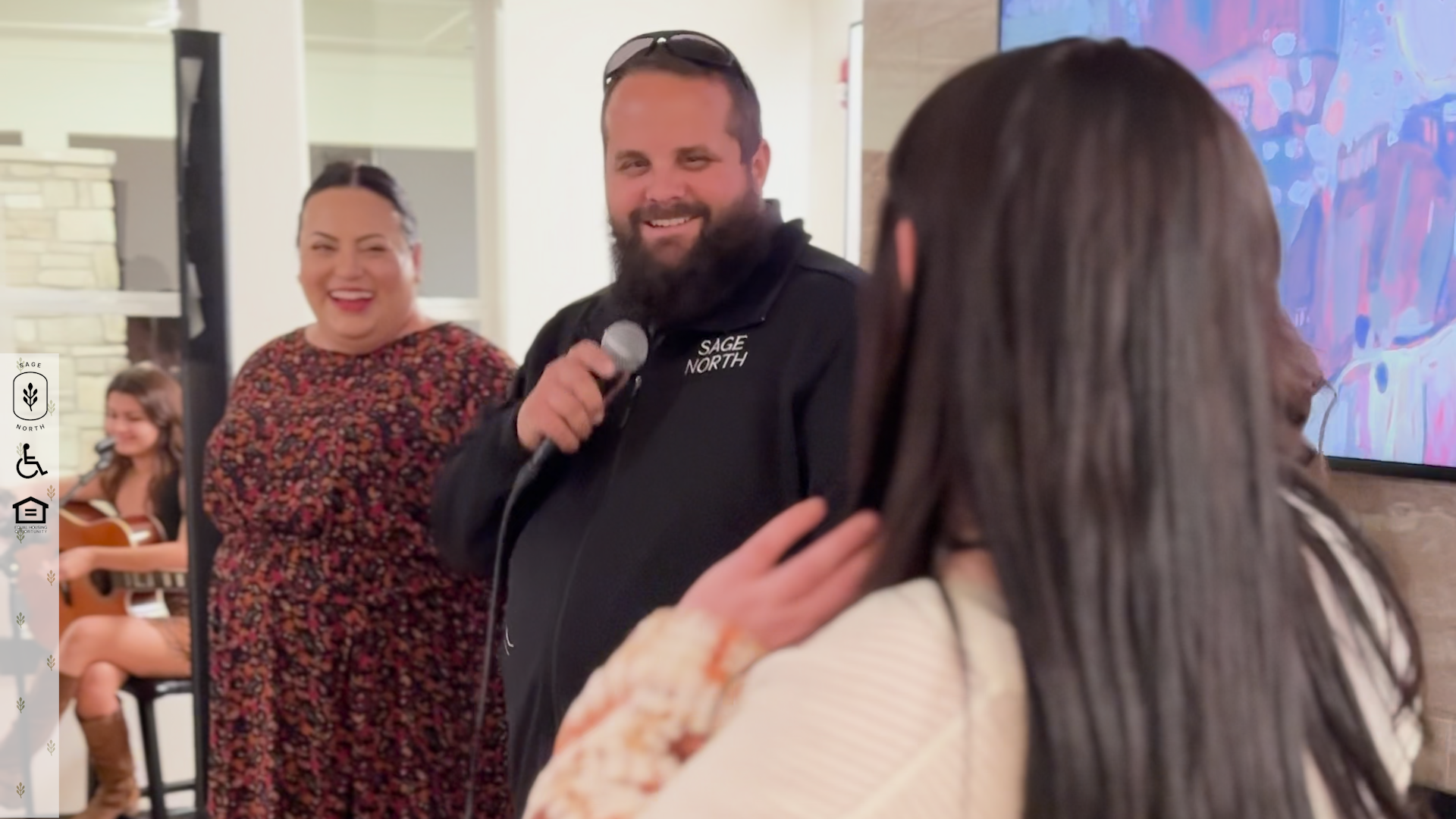 The staff at Sage North enjoy a laugh together at a community event The staff at Sage North enjoy a laugh together at a community event