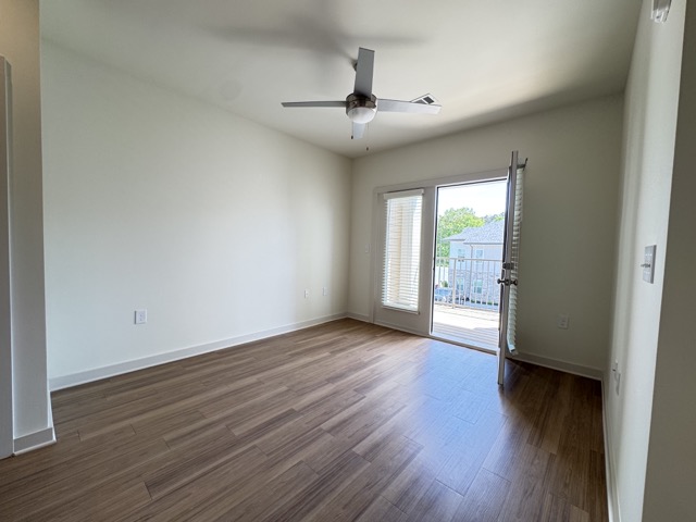 Living area and door to balcony in 1b/1b Alley Floor Plan Apartment at Sage North in White House, Tennessee