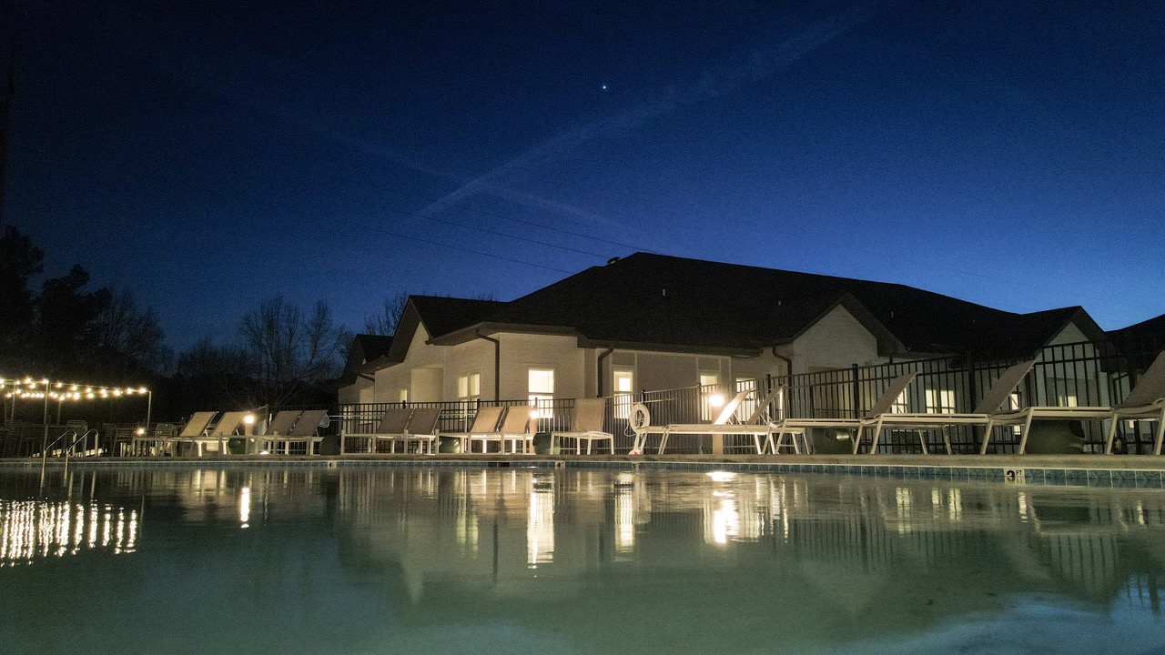 Resort-Style Pool at Sage North – Luxury Living in White House, TN A beautifully lit resort-style pool at Sage North in White House, Tennessee, offering a relaxing atmosphere for residents in the evening.