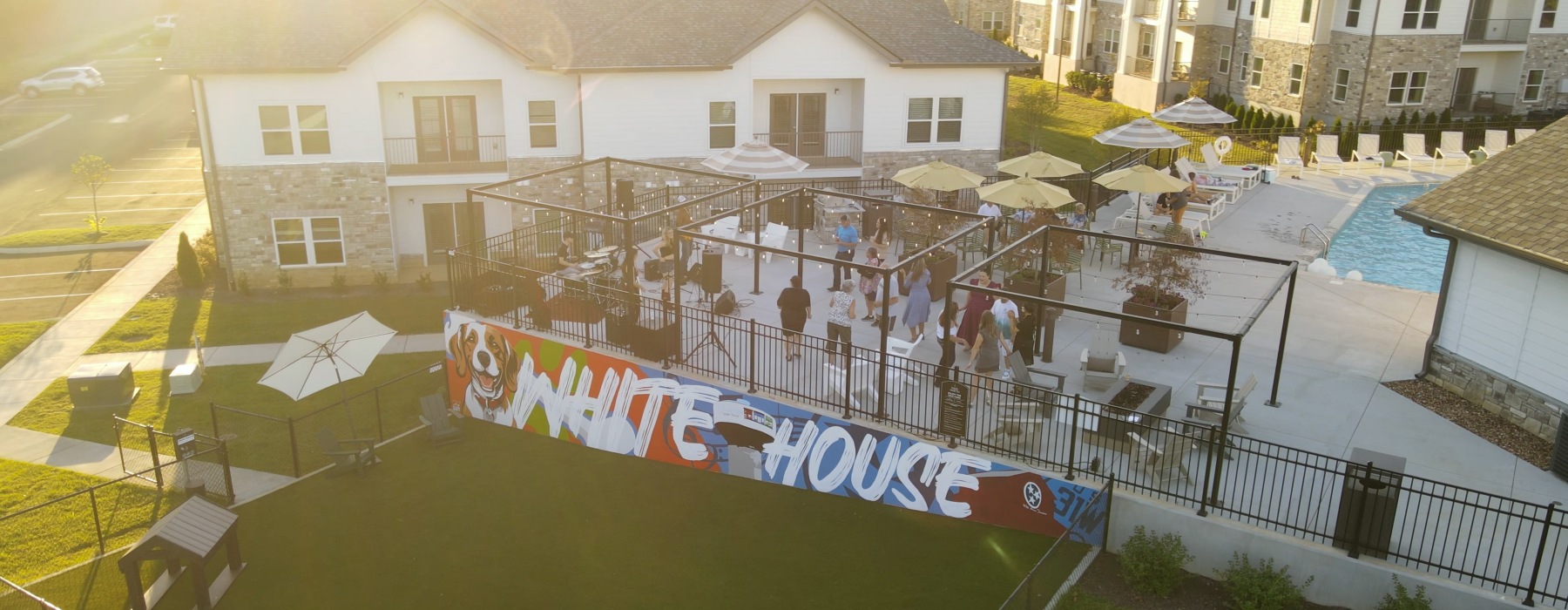 A group of residents enjoy live music on the sun deck at a resort-style apartment community in White House, Tennessee