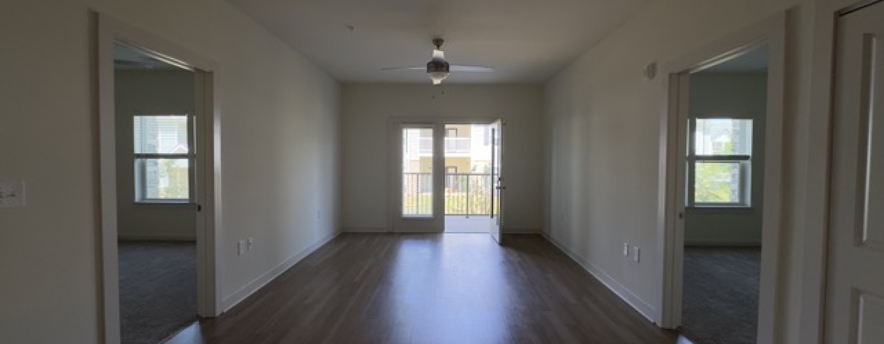 Wide view of Channel Floor Plan Living Area and doors to both bedrooms