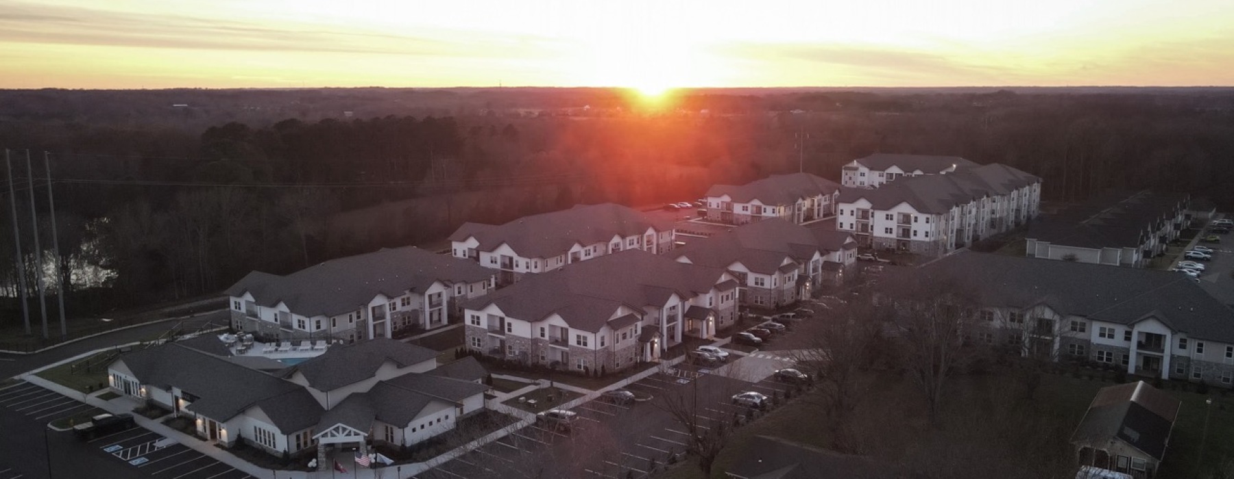 Aerial View of Sage North – Luxury Apartments in White House, TN A stunning aerial view of Sage North in White House, Tennessee, showcasing the luxury apartment community at sunset.