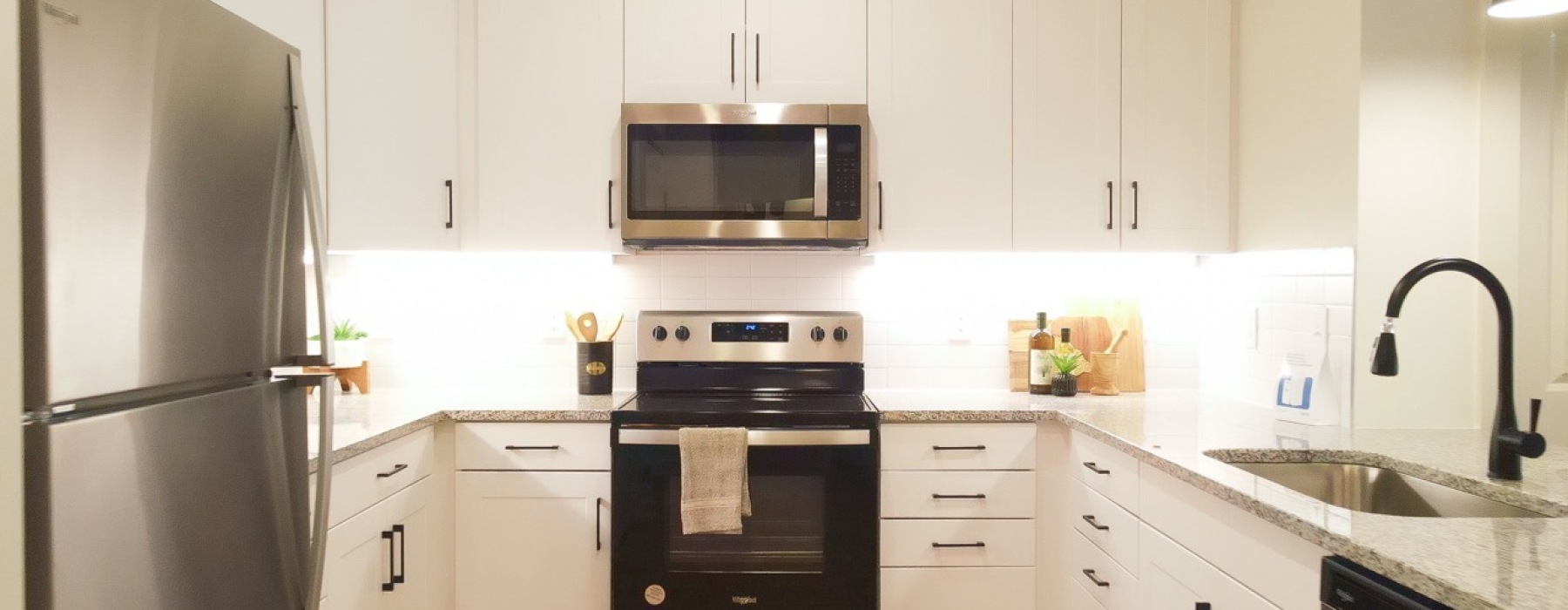 Modern Kitchen with Stainless Steel Appliances at Sage North Contemporary kitchen featuring white cabinetry at Sage North apartments in White House, TN.