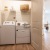 double door laundry closet with lighting and side-by-side washer/dryer units