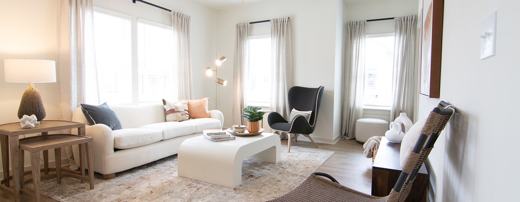 Spacious living room surrounded by windows at Sage North apartments in White House, TN.