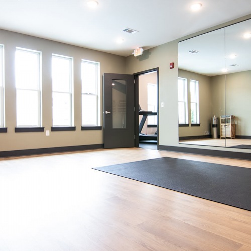 Yoga Studio Yoga studio with mirror wall and bright windows at Sage North apartments in White House, TN.